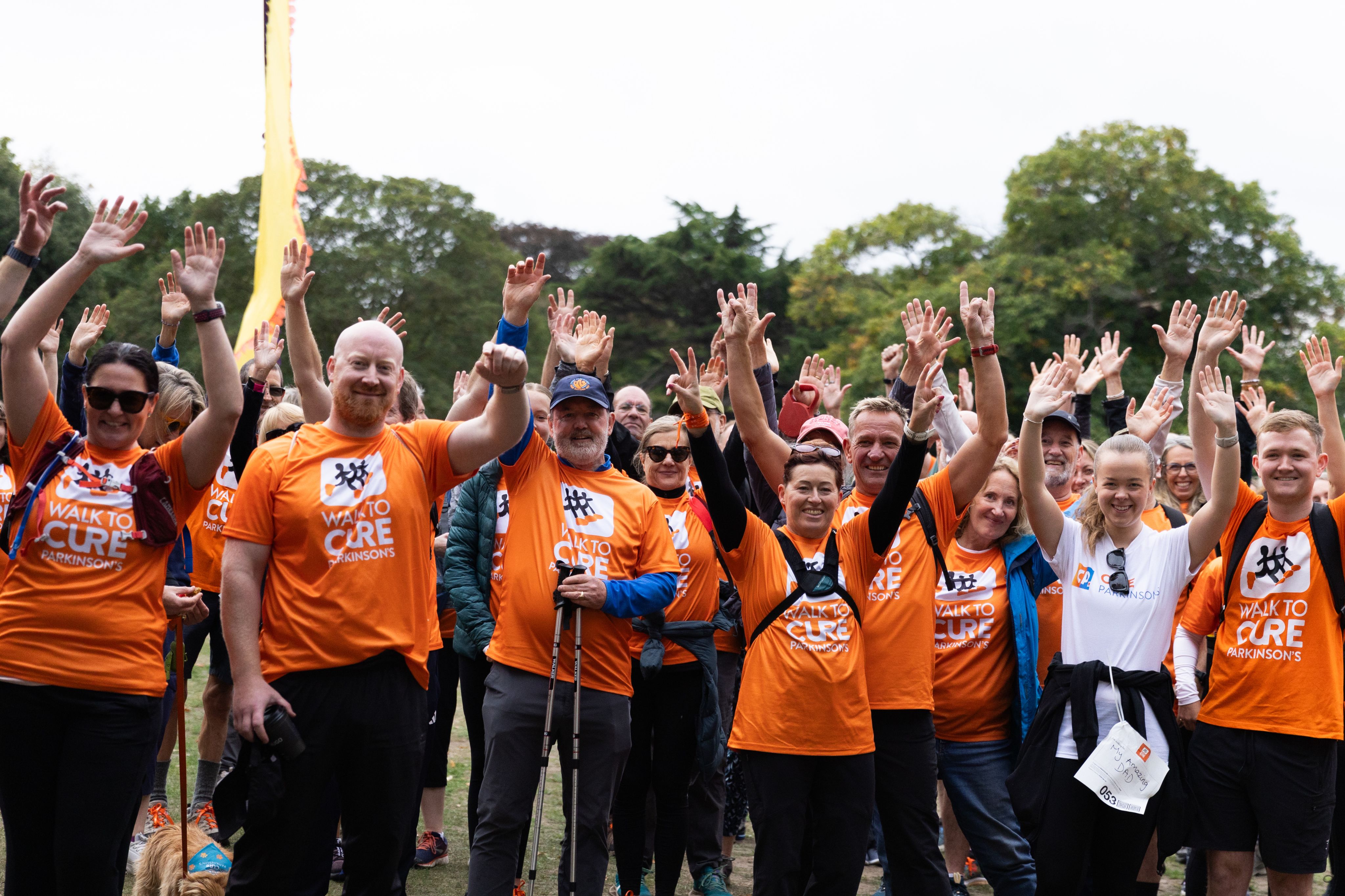 A group of our fundraising walkers cheering at our Walk To Cure Parkinson's.