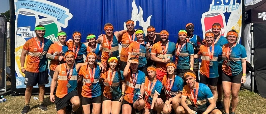 Tough Mudder participants in Cure Parkinson's tops pose for photo