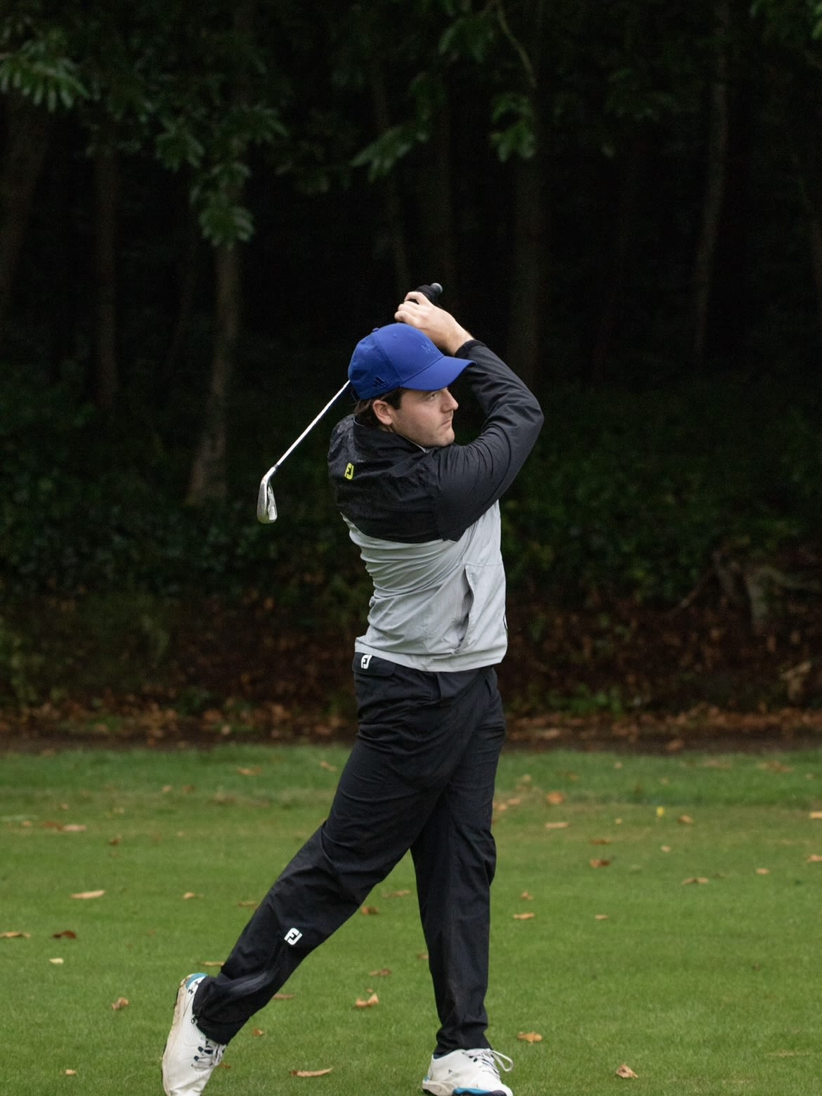 Tommy Harshorn swinging his golf club on a golf course.