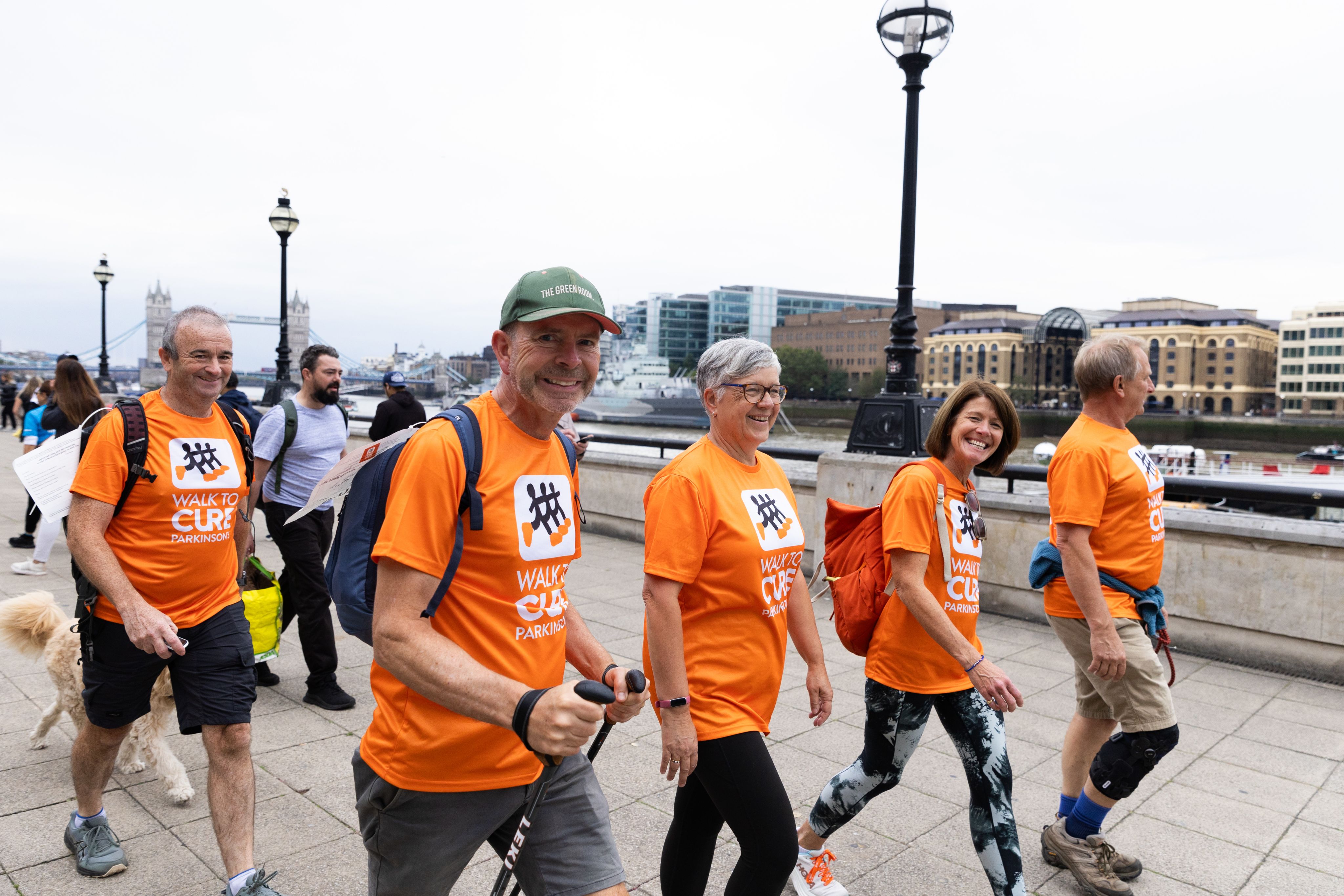 A group of Cure Parkinson's walkers walking along the South Bank of London. 
