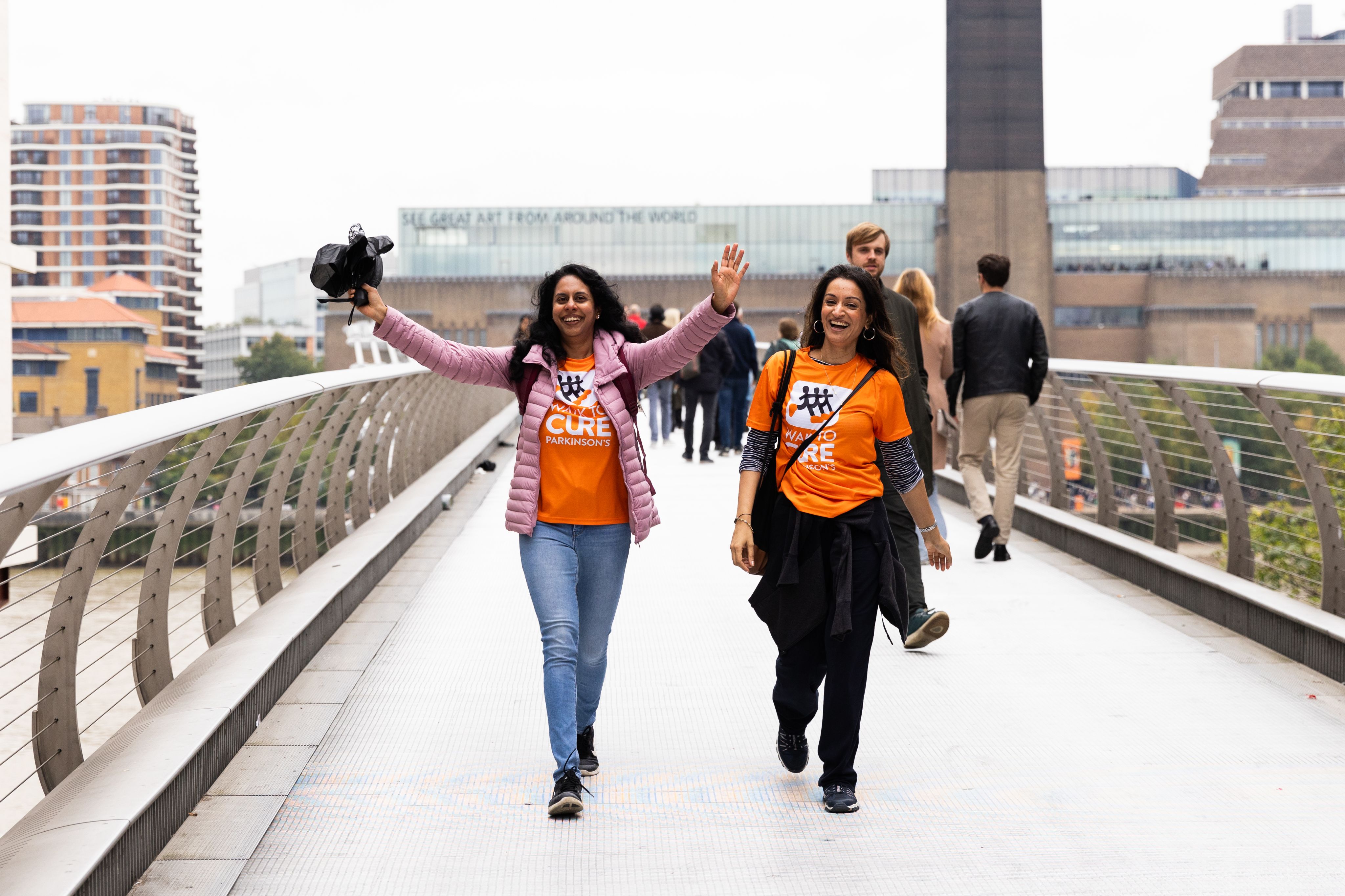 Two fundraisers crossing the Millennium Bridge